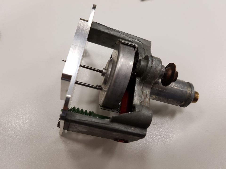 Close-up of an electric motor with gears and a metal bracket attached