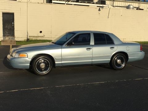 2006 Ford Crown Victoria - Side profile of a light blue 2006 Ford Crown Victoria parked on asphalt.