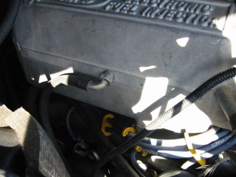 1985 Ford Bronco - Close-up view of an engine bay, highlighting the "ELECTRONIC FUEL INJECTION" text on a component.