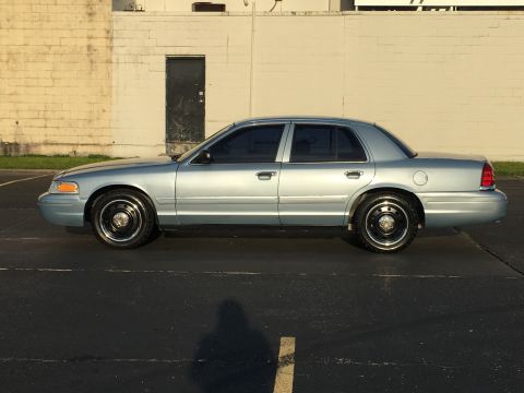 2006 Ford Crown Victoria - This 2006 Ford Crown Victoria is captured in a side profile, its classic sedan body style.