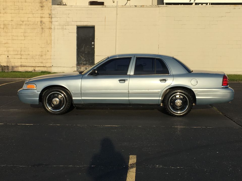 Light blue 2006 Ford Crown Victoria sedan, side view