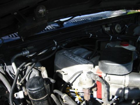 1985 Ford Bronco - Close-up view of an engine bay, showing numerous engine parts and wiring.