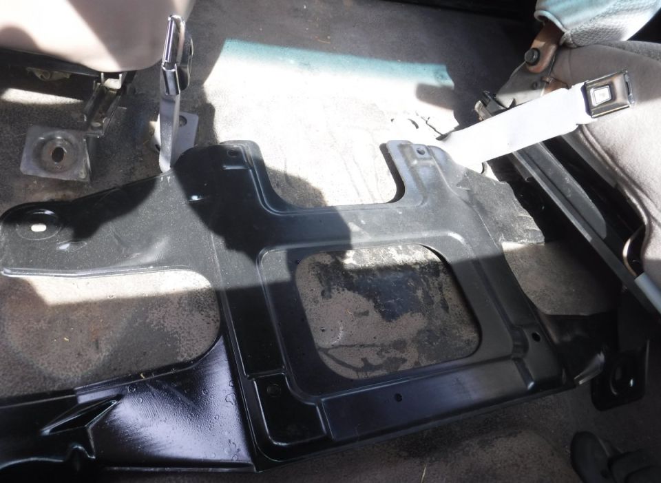 F-series center jump seat bracket interferes with Bronco's floor-mounted seat belt receivers.