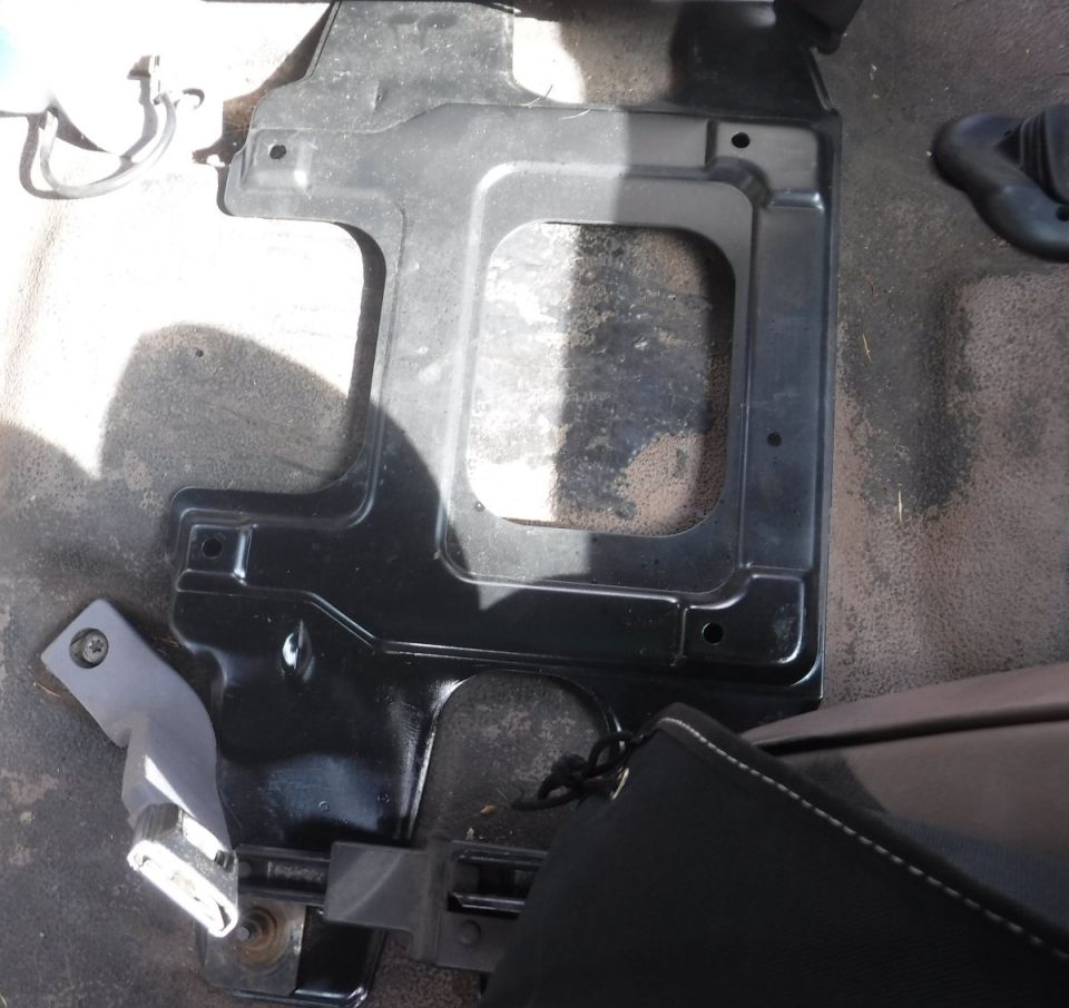 F-series center jump seat bracket interferes with Bronco's floor-mounted seat belt receivers.