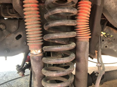 1995 Ford Bronco - The image shows the front suspension system of a vehicle, including coil springs and shock absorbers.