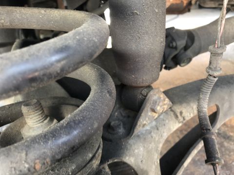 1995 Ford Bronco - Detail of rear suspension parts, showing a coil spring and shock absorber assembly.