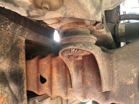 1995 Ford Bronco - Close-up of worn suspension parts, showing significant rust and damage.