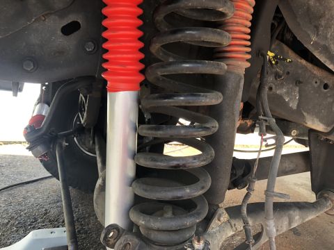 1995 Ford Bronco - Vehicle suspension system components including a coil spring and shock absorber are visible.