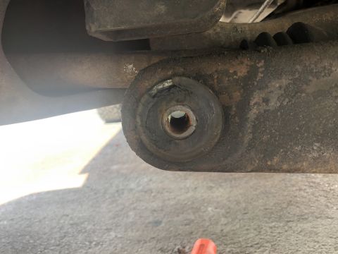 1995 Ford Bronco - This photo shows a close-up view of a worn suspension bushing, indicating a need for replacement.