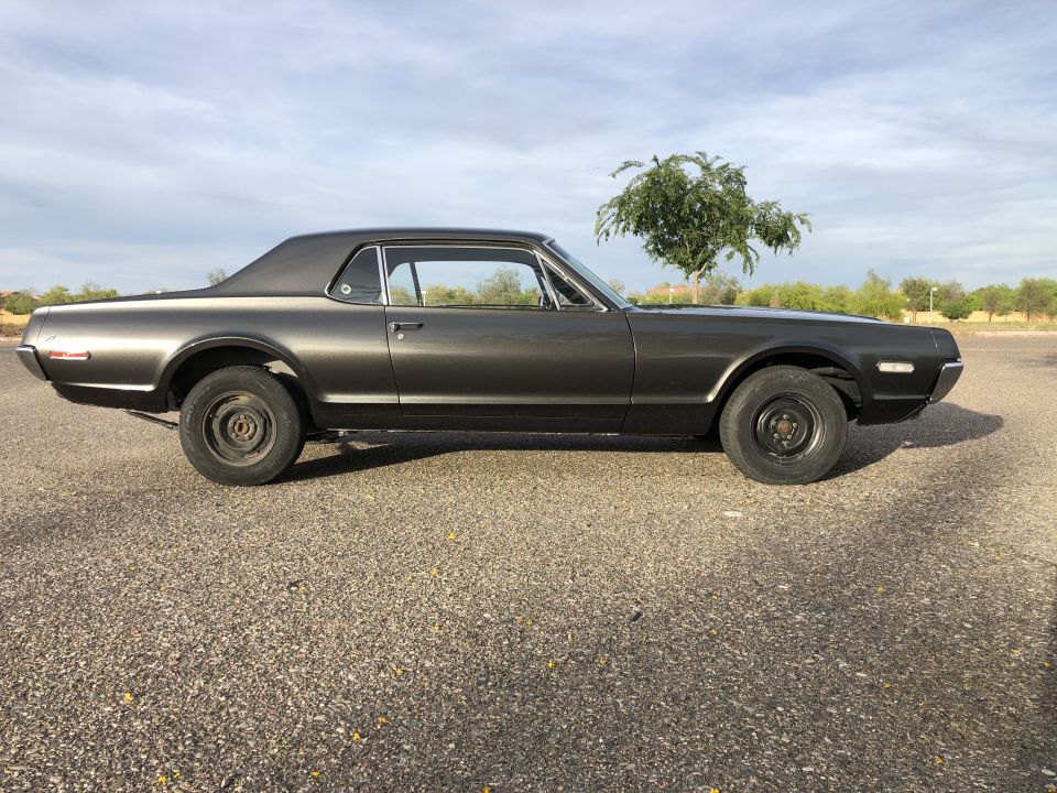 Gray 1968 Mercury Cougar coupe parked on gravel, side view