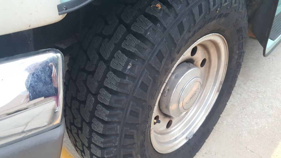 Close-up of a Pirelli Scorpion AT tire and silver alloy wheel on a vehicle.