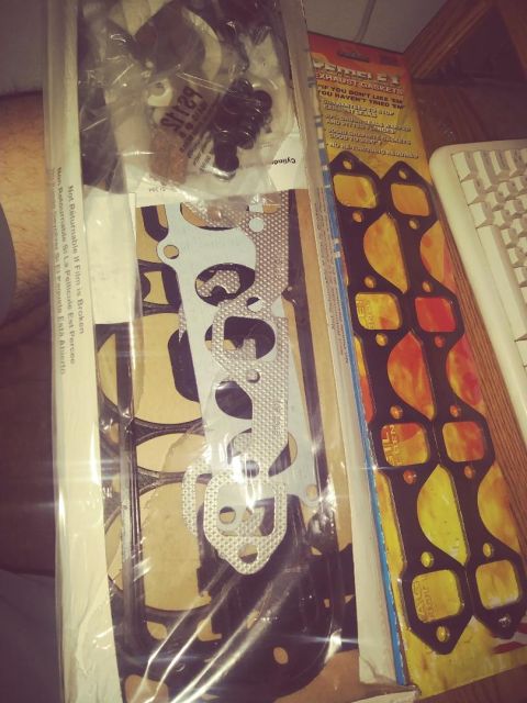 1996 Ford Bronco - A close-up view of a gasket set for a vehicle, including exhaust manifold gaskets and other engine gaskets. The packaging for the exhaust g…