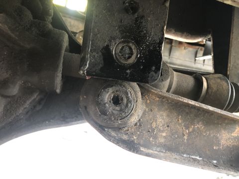 1995 Ford Bronco - This is a close-up, low-angle shot of the underside of a vehicle's suspension system, likely from a 1995 Ford Bronco. The image focuses on…