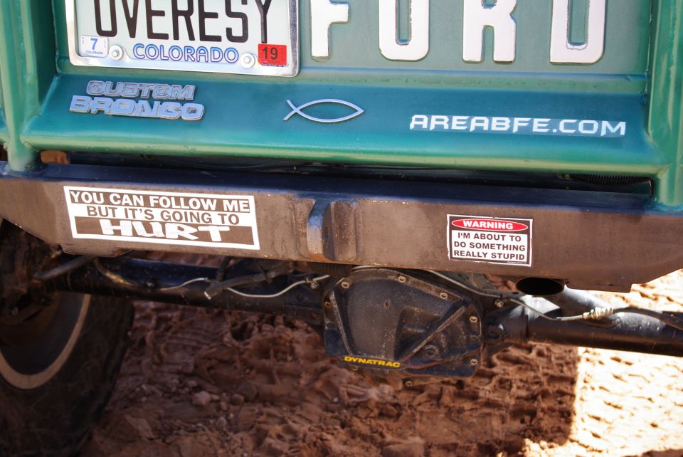 Rear bumper of a green Ford Bronco with bumper stickers and a Dynatrac differential cover.