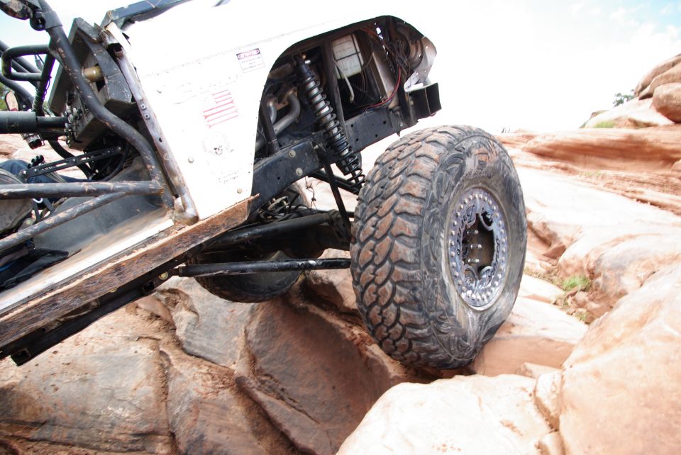 Off-road vehicle with large tires on rocky terrain