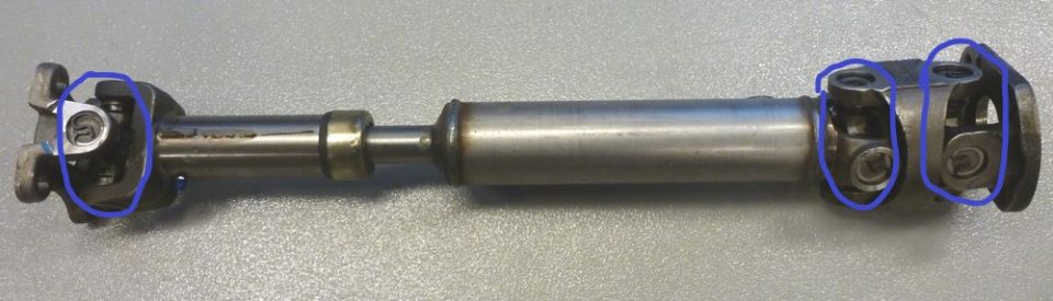 Driveshaft with two universal joints and a center bearing.