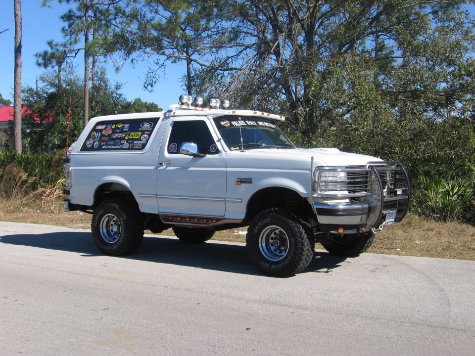 White Ford Bronco parked on a sunny day, viewed from the front three-quarter angle