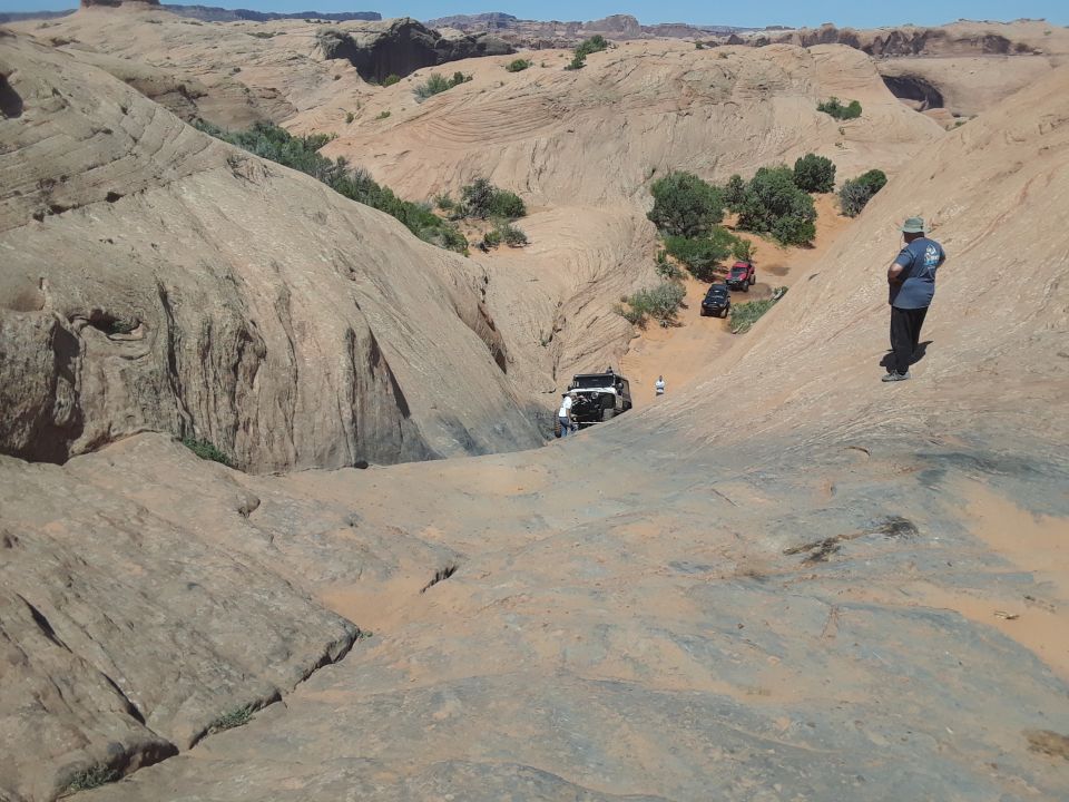 Desert landscape with sandy hills and a lone person standing