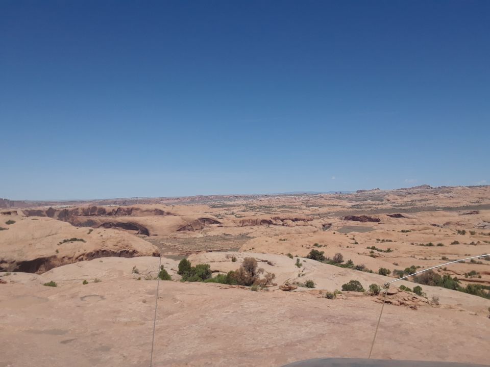 Desert landscape with rock formations under a clear blue sky
