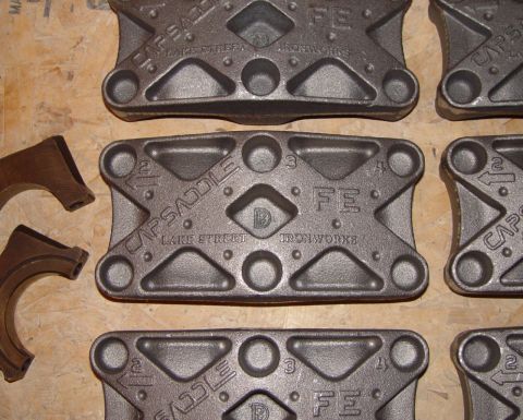 1969 Ford Fairlane - Several cast iron parts, possibly for an engine, are laid out on a wooden surface. Text visible includes 'CAPSADDLE', 'LAKE STREET', and 'F…