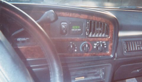 1991 Ford Taurus - Dashboard of a 1991 Ford Taurus, wood grain trim and a digital display.