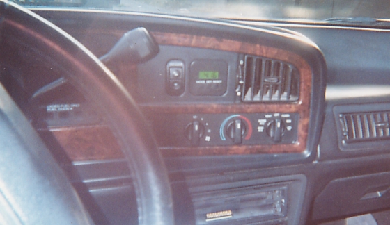Instrument panel and HVAC controls of a vehicle with woodgrain dash trim