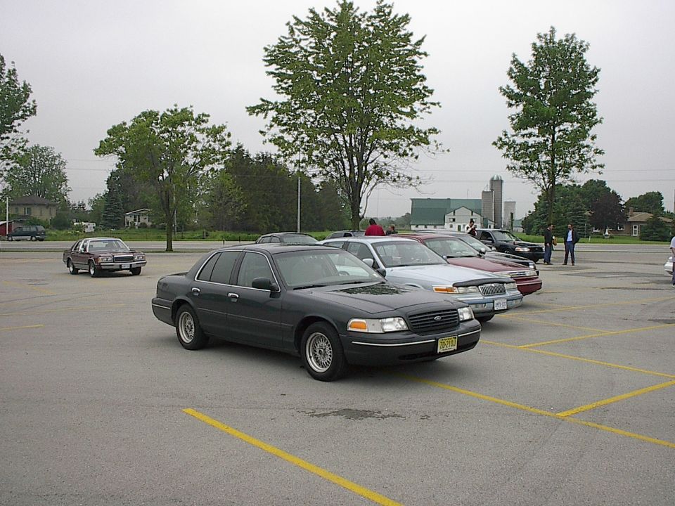 Dark gray sedan parked in a lot, 3/4 front view.