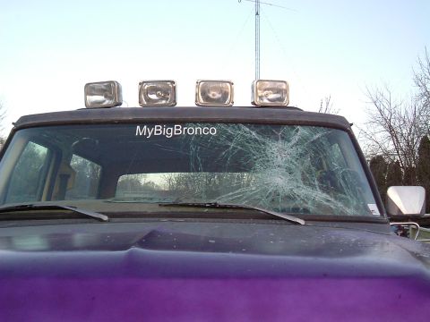 1979 Ford Bronco - Ford Bronco with a severely cracked windshield and roof-mounted lights. The "MyBigBronco" sticker is visible.