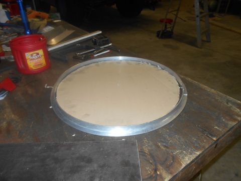 1992 Ford Bronco - A circular piece of cardboard sits within a metal rim on a wooden workbench. To the left, a red Folgers coffee can and various tools are vi…