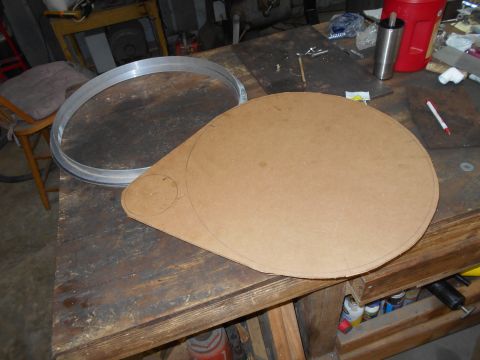 1992 Ford Bronco - A large circular piece of cardboard with a smaller circle drawn inside it is laid out on a wooden workbench. A metal ring is also visible o…