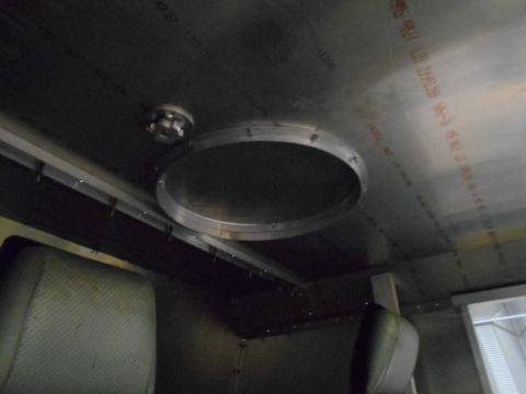 1992 Ford Bronco - Interior view of a vehicle's ceiling showing a circular opening with a metal ring and a small circular fixture above it. The ceiling appear…