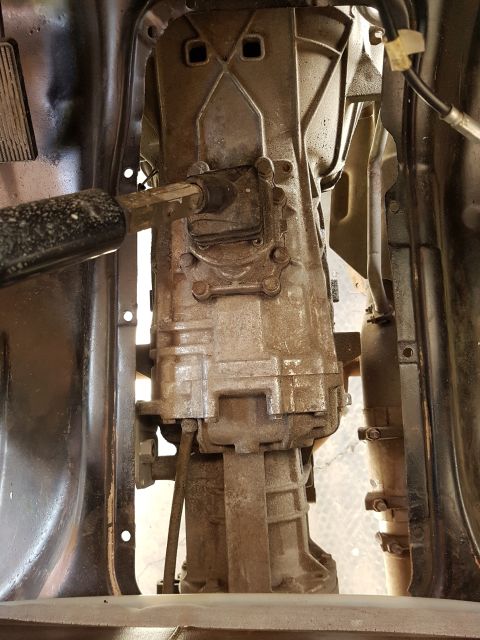 1978 Ford Bronco - This is a close-up, overhead view of a transfer case and part of a transmission assembly, likely from a 1978 Ford Bronco. The components ar…