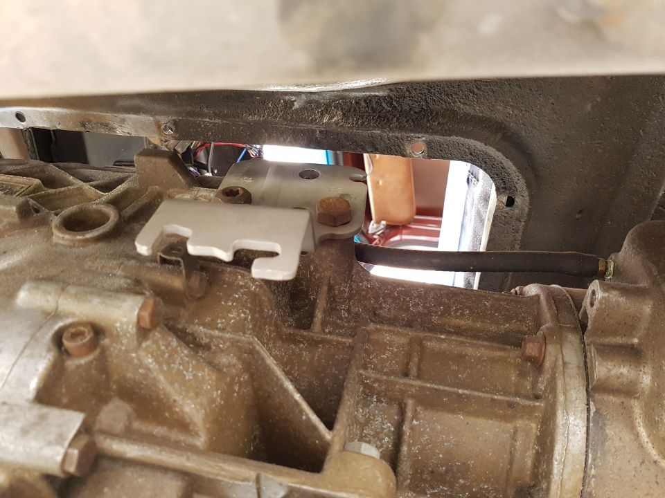 Inside of an old vehicle, looks like the back seat area and some of the roof