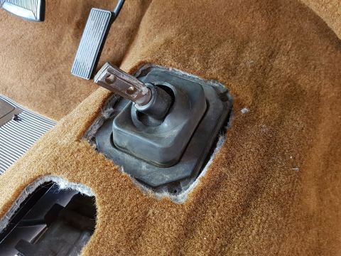 1978 Ford Bronco - The interior floor of a vehicle shows the brake and accelerator pedals, along with the opening for a shifter boot.