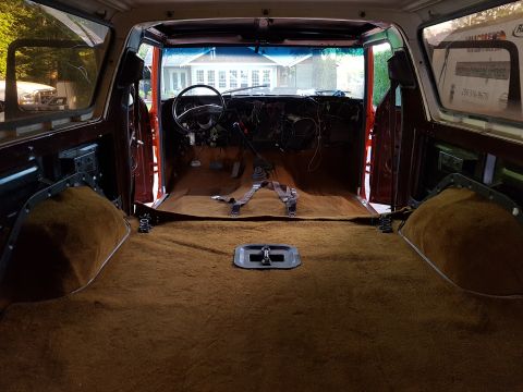 1978 Ford Bronco - The interior of a 1978 Ford Bronco shows a disassembled dashboard and brown carpet.