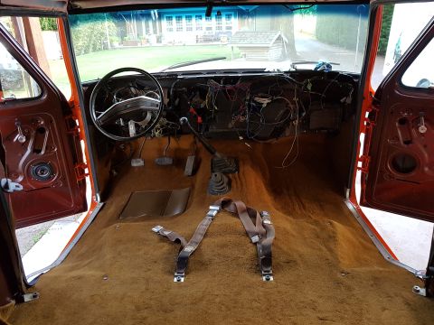1978 Ford Bronco - The interior of a 1978 Ford Bronco shows exposed wiring and a brown carpet, indicating a project in progress.