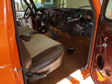 1978 Ford Bronco - Interior view of a 1978 Ford Bronco with dashboard wiring exposed and seats visible.