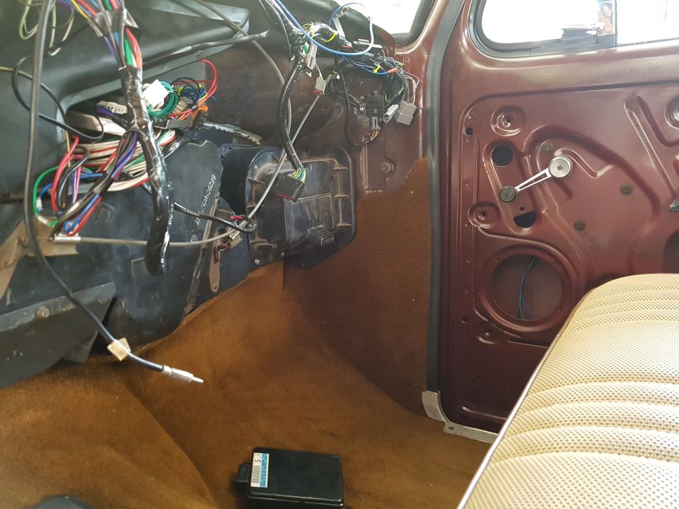1978 Ford Bronco interior with exposed wiring and brown carpet