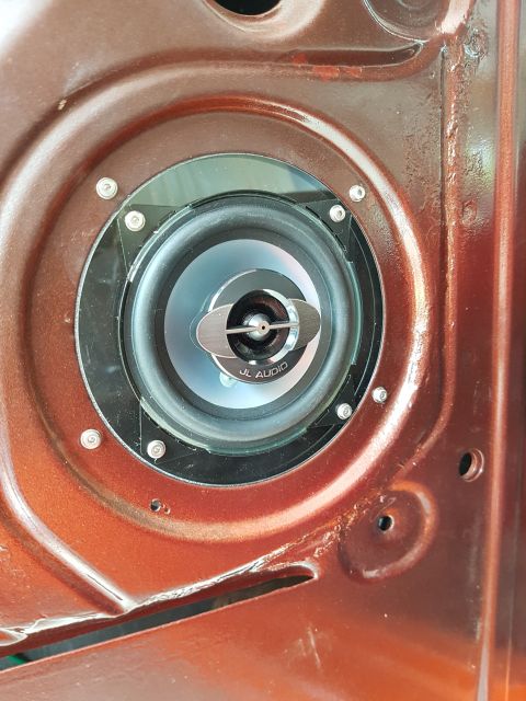 1978 Ford Bronco - Aftermarket speaker installation in a vehicle's door panel.