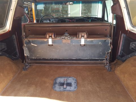 1978 Ford Bronco - The cargo area of a 1978 Ford Bronco shows a folded rear seat and brown carpeting.