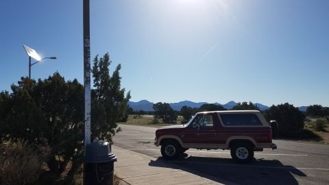 1985 Ford Bronco - This 1985 Ford Bronco is seen parked on a sunny day with mountains in the background.