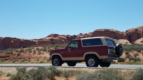 1985 Ford Bronco - This two-tone 1985 Ford Bronco is captured in a scenic desert environment.