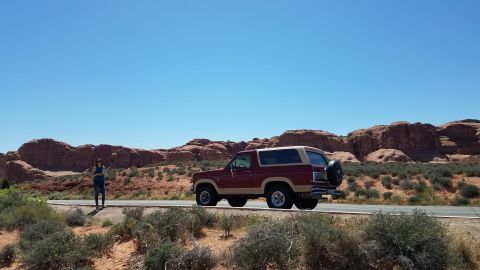 1985 Ford Bronco - A 1985 Ford Bronco is seen on a road trip through a desert landscape.