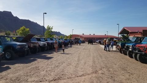 1985 Ford Bronco - A group of Ford Broncos are parked in a lot during an event.