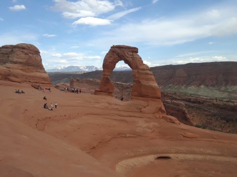 1985 Ford Bronco - Tourists visit Delicate Arch, a famous landmark in Arches National Park, Utah.