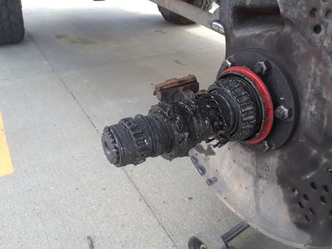 1985 Ford Bronco - Close-up of a damaged wheel hub assembly, showing signs of wear and tear.