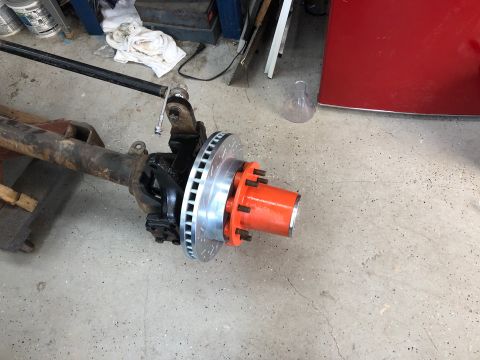 1992 Jeep Wrangler - A front axle assembly with a newly installed disc brake rotor and an orange painted hub is shown.