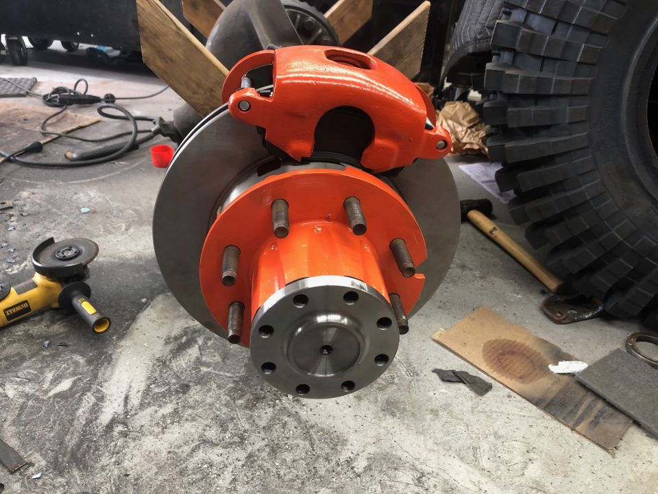 Orange brake caliper and rotor assembly with a large hub