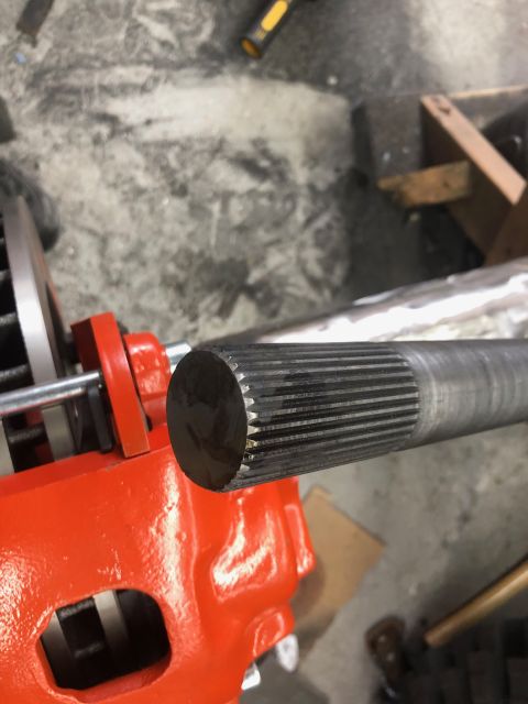 1992 Jeep Wrangler - Splined axle shaft and differential housing shown in a workshop setting.