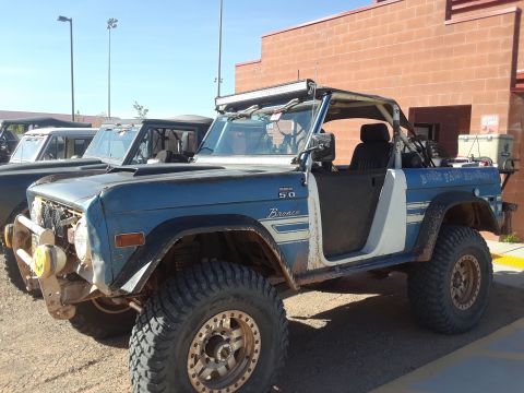 1985 Ford Bronco - This modified Ford Bronco features off-road tires, a light bar, and custom paintwork.